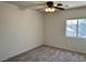 Bedroom featuring neutral walls, a ceiling fan, and a window allowing natural light at 9452 Plover Falls Ave, Las Vegas, NV 89149