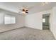 Bright, carpeted bonus room featuring a ceiling fan and bright windows at 9452 Plover Falls Ave, Las Vegas, NV 89149