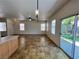 Bright dining area with tile floors, a modern light fixture, and sliding glass doors leading to the backyard at 9452 Plover Falls Ave, Las Vegas, NV 89149