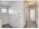 Well-lit hallway with neutral tones and soft carpeting, providing a welcoming transition between rooms at 9452 Plover Falls Ave, Las Vegas, NV 89149