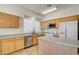 Well-lit kitchen has a center island, stainless steel sink, and ample counter space at 9452 Plover Falls Ave, Las Vegas, NV 89149