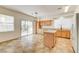 Bright kitchen features wooden cabinets, center island, and sliding glass doors to the backyard at 9452 Plover Falls Ave, Las Vegas, NV 89149