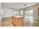 Bright open-concept kitchen has a center island, ceiling fan, and backyard access at 9452 Plover Falls Ave, Las Vegas, NV 89149