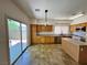 Well-equipped kitchen featuring oak cabinets, stainless steel appliances, and a view of the outdoor patio at 9452 Plover Falls Ave, Las Vegas, NV 89149