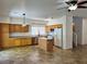 Bright kitchen with oak cabinets, stainless steel appliances, an island, and tile flooring at 9452 Plover Falls Ave, Las Vegas, NV 89149
