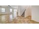 Spacious living room with tile flooring, natural light, and an open staircase at 9452 Plover Falls Ave, Las Vegas, NV 89149