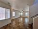 Bright living room with tiled floors, large windows allowing ample natural light and a ceiling fan at 9452 Plover Falls Ave, Las Vegas, NV 89149