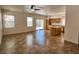 Open-concept living and dining area featuring tile flooring, a kitchen island, and a sliding glass door at 9452 Plover Falls Ave, Las Vegas, NV 89149