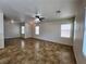 Spacious living room with tile flooring, large windows, and neutral paint, providing a bright atmosphere at 9452 Plover Falls Ave, Las Vegas, NV 89149