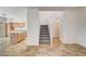 Open-concept living room features a kitchen, stairs, and tile floors at 9452 Plover Falls Ave, Las Vegas, NV 89149