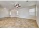 Bright and airy living room featuring neutral walls and tile flooring for low maintenance at 9452 Plover Falls Ave, Las Vegas, NV 89149