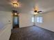 Versatile loft area with neutral carpet, a ceiling fan, and plenty of space for various activities or relaxation at 9452 Plover Falls Ave, Las Vegas, NV 89149
