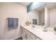 Bathroom featuring a large mirror, well-lit vanity with white cabinets, and sleek design at 10400 Luna Mezzo St Ave # Lot 193, Las Vegas, NV 89141