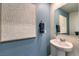 Stylish half bathroom with pedestal sink, decorative mirror, and modern wall art at 10400 Luna Mezzo St Ave # Lot 193, Las Vegas, NV 89141