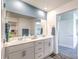 Bright bathroom featuring double sinks, a large mirror, and tasteful decor with blue accents at 10400 Luna Mezzo St Ave # Lot 193, Las Vegas, NV 89141