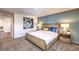Spacious bedroom features stylish wall art, a modern woven bed frame, and ample natural light at 10400 Luna Mezzo St Ave # Lot 193, Las Vegas, NV 89141