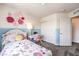 room boasting a floral bed, decorative wall art, and a practical desk and closet space at 10400 Luna Mezzo St Ave # Lot 193, Las Vegas, NV 89141