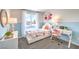 Charming bedroom with floral accents, decorative lamps, and a white desk for studying and creativity at 10400 Luna Mezzo St Ave # Lot 193, Las Vegas, NV 89141