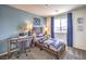 Charming bedroom with blue accent wall, work desk, and twin bed with shark decorations at 10400 Luna Mezzo St Ave # Lot 193, Las Vegas, NV 89141