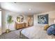 Cozy bedroom features a wood cabinet with round mirror, decorative plant and an open hallway to the bathroom at 10400 Luna Mezzo St Ave # Lot 193, Las Vegas, NV 89141