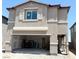Two-story tan home featuring an attached two-car garage and unfinished landscaping at 10400 Luna Mezzo St Ave # Lot 193, Las Vegas, NV 89141