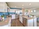 Bright kitchen featuring stainless appliances, white cabinets, and a kitchen island with sink at 10400 Luna Mezzo St Ave # Lot 193, Las Vegas, NV 89141