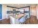 Modern kitchen features white cabinetry, stainless steel appliances, and a large island with seating at 10400 Luna Mezzo St Ave # Lot 193, Las Vegas, NV 89141