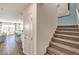 View of open living space with kitchen island, dining area, and staircase with carpet at 10400 Luna Mezzo St Ave # Lot 193, Las Vegas, NV 89141