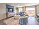 Comfortable living space with stylish furnishings, flowing onto the outdoor patio with a brick wall at 10400 Luna Mezzo St Ave # Lot 193, Las Vegas, NV 89141