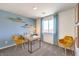 Bright home office featuring modern desk with yellow chairs and plenty of natural light for a productive workspace at 10400 Luna Mezzo St Ave # Lot 193, Las Vegas, NV 89141