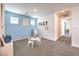 Bright playroom with blue accent wall, table and chairs, and plenty of space for activities at 10400 Luna Mezzo St Ave # Lot 193, Las Vegas, NV 89141