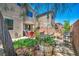Spacious backyard featuring outdoor seating, a shady tree, and lush landscaping, perfect for relaxation and entertainment at 10692 Tulip Valley Rd, Las Vegas, NV 89179