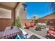 Inviting backyard featuring a covered patio, cozy seating, and a fire pit, perfect for outdoor gatherings and relaxation at 10692 Tulip Valley Rd, Las Vegas, NV 89179