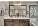 Bathroom with double vanity, soaking tub, and decorative mirror at 10692 Tulip Valley Rd, Las Vegas, NV 89179
