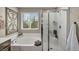 Bathroom featuring a soaking tub, separate shower, and natural lighting at 10692 Tulip Valley Rd, Las Vegas, NV 89179