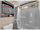 Clean bathroom featuring a white tiled shower/tub combo with blue accents, neutral walls and dark grey accents at 10692 Tulip Valley Rd, Las Vegas, NV 89179