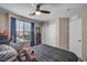 Comfortable bedroom featuring a ceiling fan, window with blinds, and spacious closet for ample storage at 10692 Tulip Valley Rd, Las Vegas, NV 89179