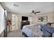 Spacious bedroom with a comfortable bed, dresser with TV, and an en-suite bathroom in the background at 10692 Tulip Valley Rd, Las Vegas, NV 89179