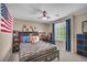Nicely decorated bedroom with a black bed frame, decorative posters and a large window bringing in natural light at 10692 Tulip Valley Rd, Las Vegas, NV 89179