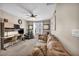 Comfortable bonus room with a ceiling fan, sofa, and a functional built-in desk and storage area at 10692 Tulip Valley Rd, Las Vegas, NV 89179