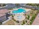An aerial view of a well-maintained community pool featuring lounge chairs and an adjacent jacuzzi at 10692 Tulip Valley Rd, Las Vegas, NV 89179
