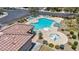 Overhead view of a community pool area with a jacuzzi, lounge chairs, a covered patio, and manicured landscaping at 10692 Tulip Valley Rd, Las Vegas, NV 89179