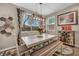 Bright dining room with modern lighting, decorative wall art, and window views at 10692 Tulip Valley Rd, Las Vegas, NV 89179
