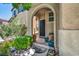 Charming front entrance with manicured landscaping, mature trees, and a welcoming walkway to the front door at 10692 Tulip Valley Rd, Las Vegas, NV 89179
