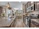 Bright kitchen with stainless steel appliances, granite countertops, and an open concept design at 10692 Tulip Valley Rd, Las Vegas, NV 89179