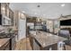 Kitchen with granite countertops, stainless steel appliances, a large island, and hardwood style flooring at 10692 Tulip Valley Rd, Las Vegas, NV 89179