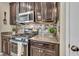 The kitchen features dark cabinets, stainless steel appliances, and granite countertops at 10692 Tulip Valley Rd, Las Vegas, NV 89179