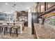 Well-equipped kitchen featuring stainless steel appliances, granite countertops, a large island, and hardwood style flooring at 10692 Tulip Valley Rd, Las Vegas, NV 89179