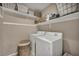 Well-organized laundry room equipped with modern washer and dryer, and ample shelving for storage at 10692 Tulip Valley Rd, Las Vegas, NV 89179