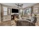 Comfortable living room showcasing modern furniture, a ceiling fan, fireplace, and hardwood style flooring at 10692 Tulip Valley Rd, Las Vegas, NV 89179